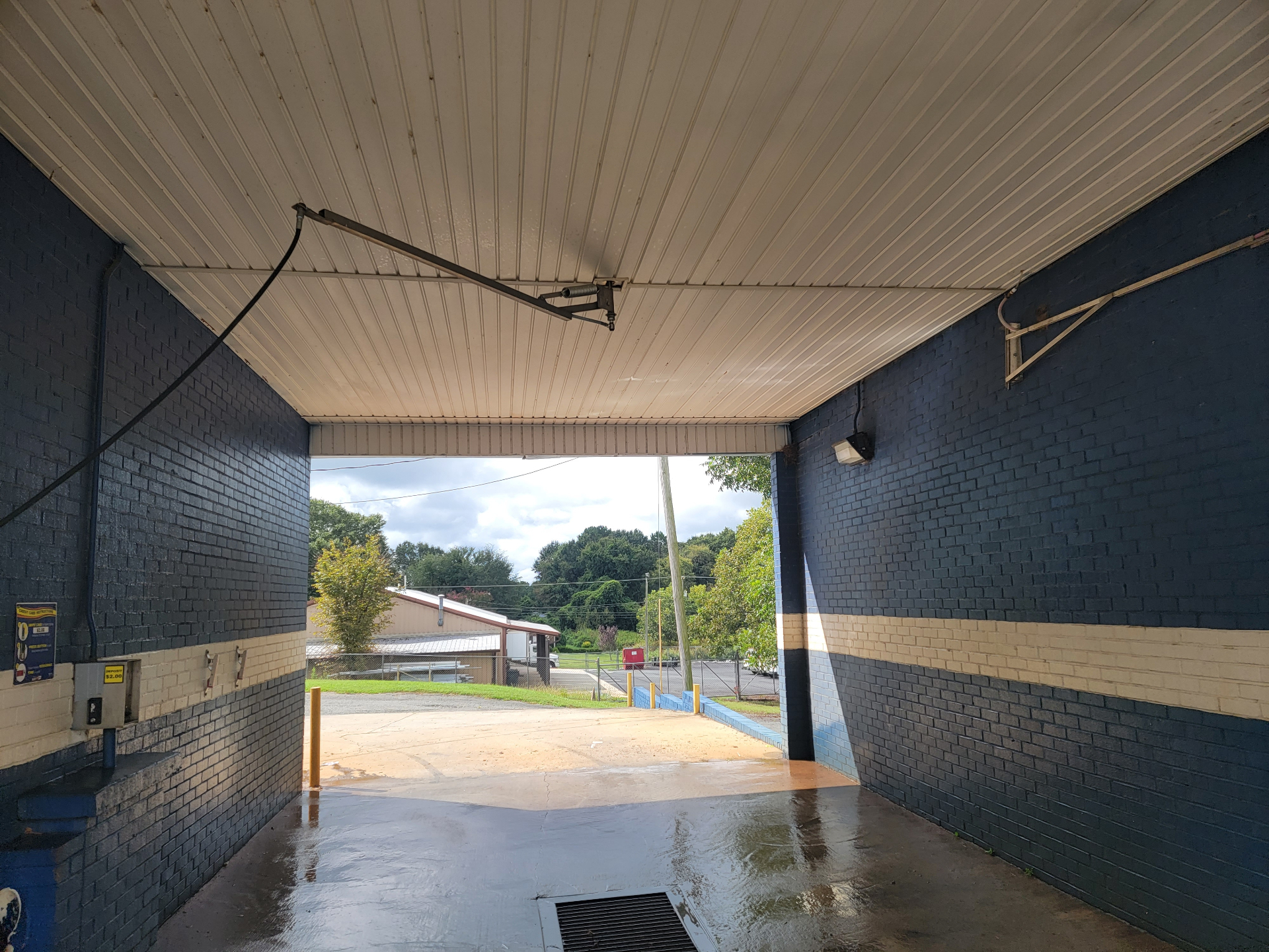 Inside a high-pressure self-serve wash bay at 609 E Trade Carwash